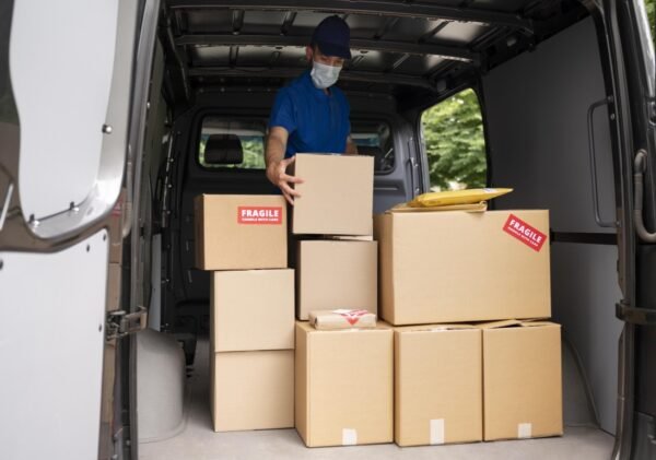 medium-shot-delivery-man-carrying-box Moving Services